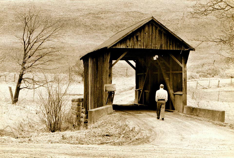 Gary walks through a covered bridge near Claysville, PA