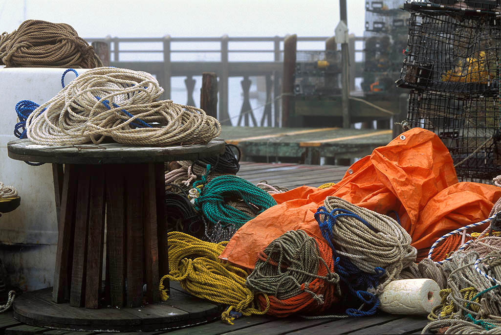 Brightly colored fishing tackle on a grey wooden dock