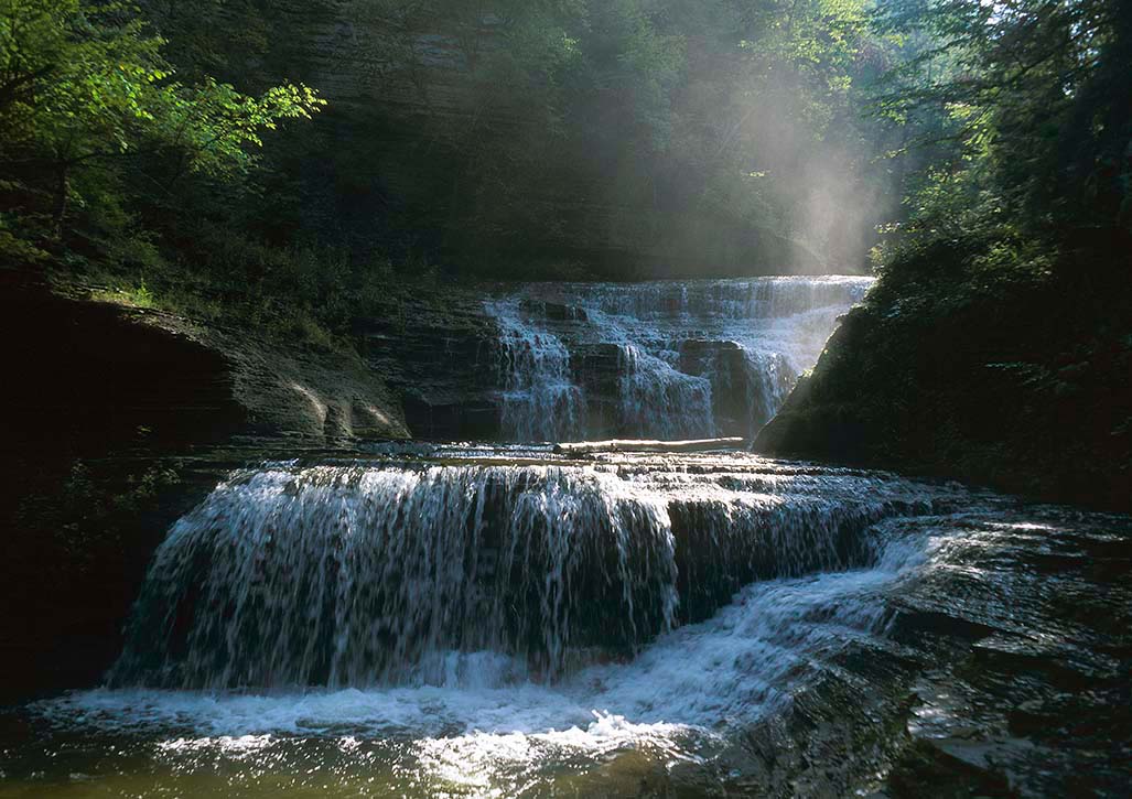 Morning mist rises from falls in (upper) Buttermilk Falls