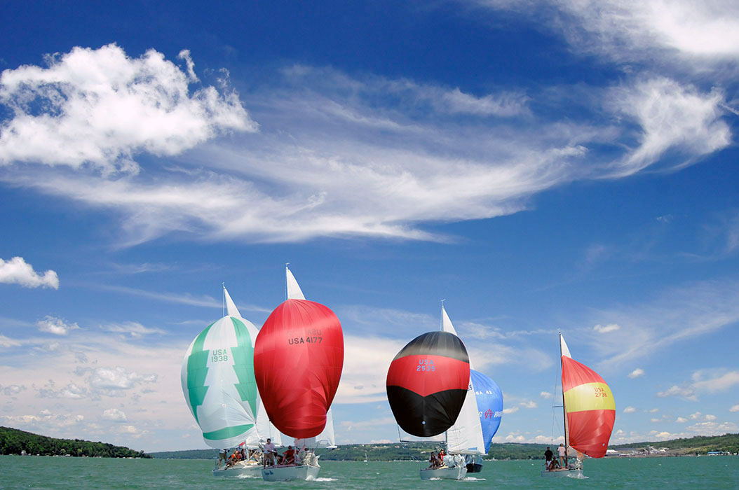 J24 Sailboats racing with spinnakers up on Cayuga Lake