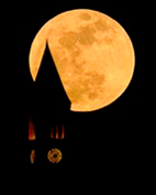 Full moon with McGraw Tower in front as seen from Cass Park